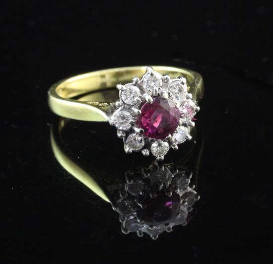 An 18ct gold ruby and diamond cluster ring, size M.